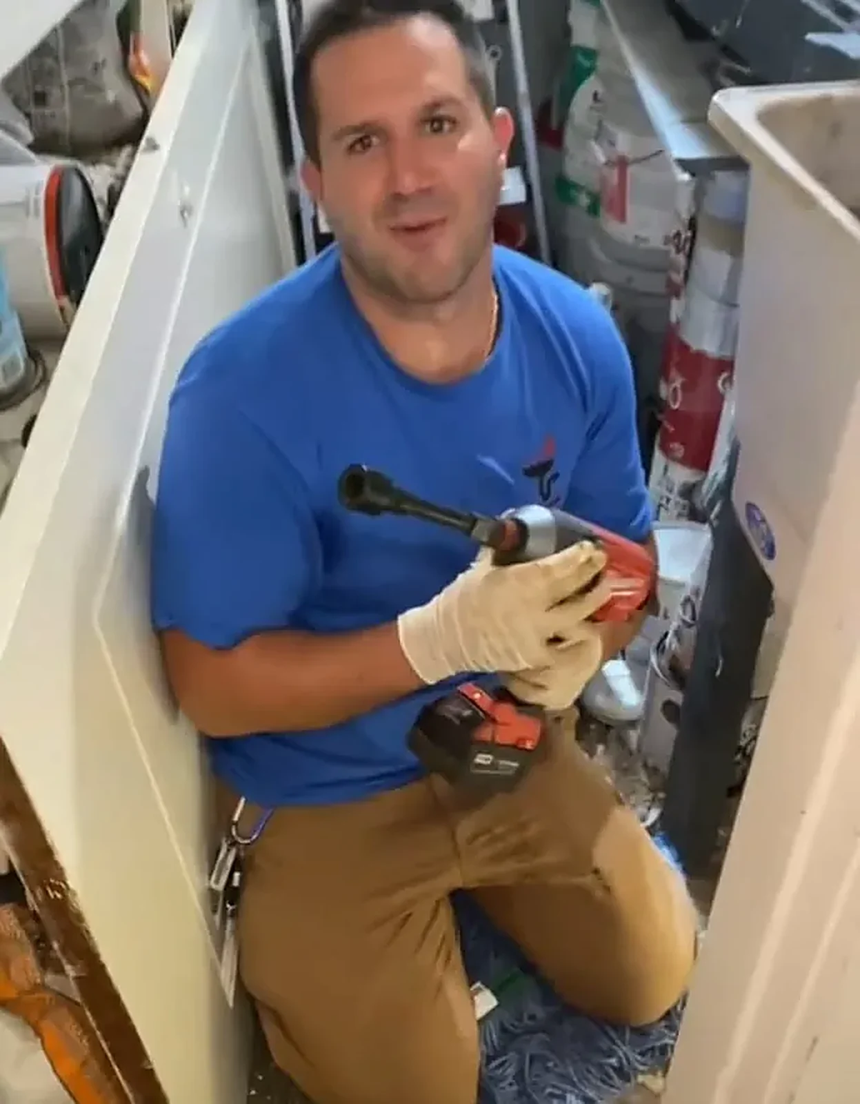 Sabra technician cleaning a kitchen sink drain